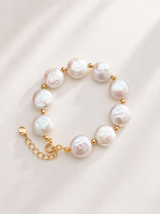 Vera Lustre "Selene" Coin Baroque Pearl Bracelet featuring iridescent flat pearls and 18K Gold Vermeil accents on a white background.