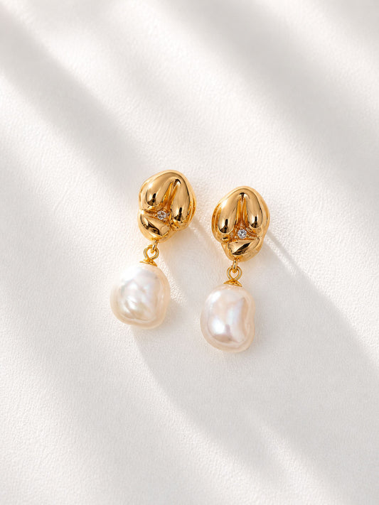 A professional studio shot of the Seraphina earrings, highlighting the uniform luster and smooth surface of the natural freshwater pearls.