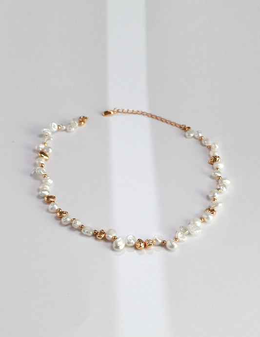 A high-resolution studio shot of the Elysian necklace on a clean background. This main image displays the striking contrast between the creamy, iridescent baroque pearls and the hand-finished silver nuggets, emphasizing the brand's commitment to handcrafted, artisan luxury jewelry.