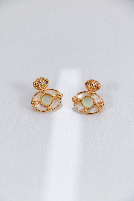 A professional studio shot of the Artemis earrings, showcasing the high-polish finish of the Green Chalcedony and the creamy, shifting luster of the Mother-of-Pearl border.