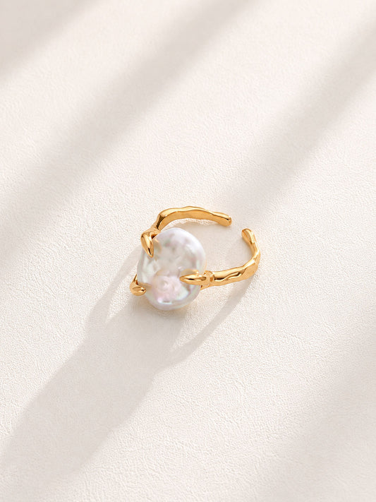 Vera Lustre "Aura" statement ring featuring a large, iridescent baroque pearl on an adjustable 18K gold vermeil fluid band.