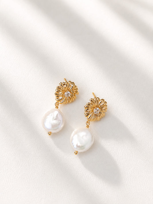 A professional studio shot of the Soleil earrings, showcasing the intricate sunflower design and the thick, lustrous baroque pearl drops. This image emphasizes the vintage gold S925 silver craftsmanship.
