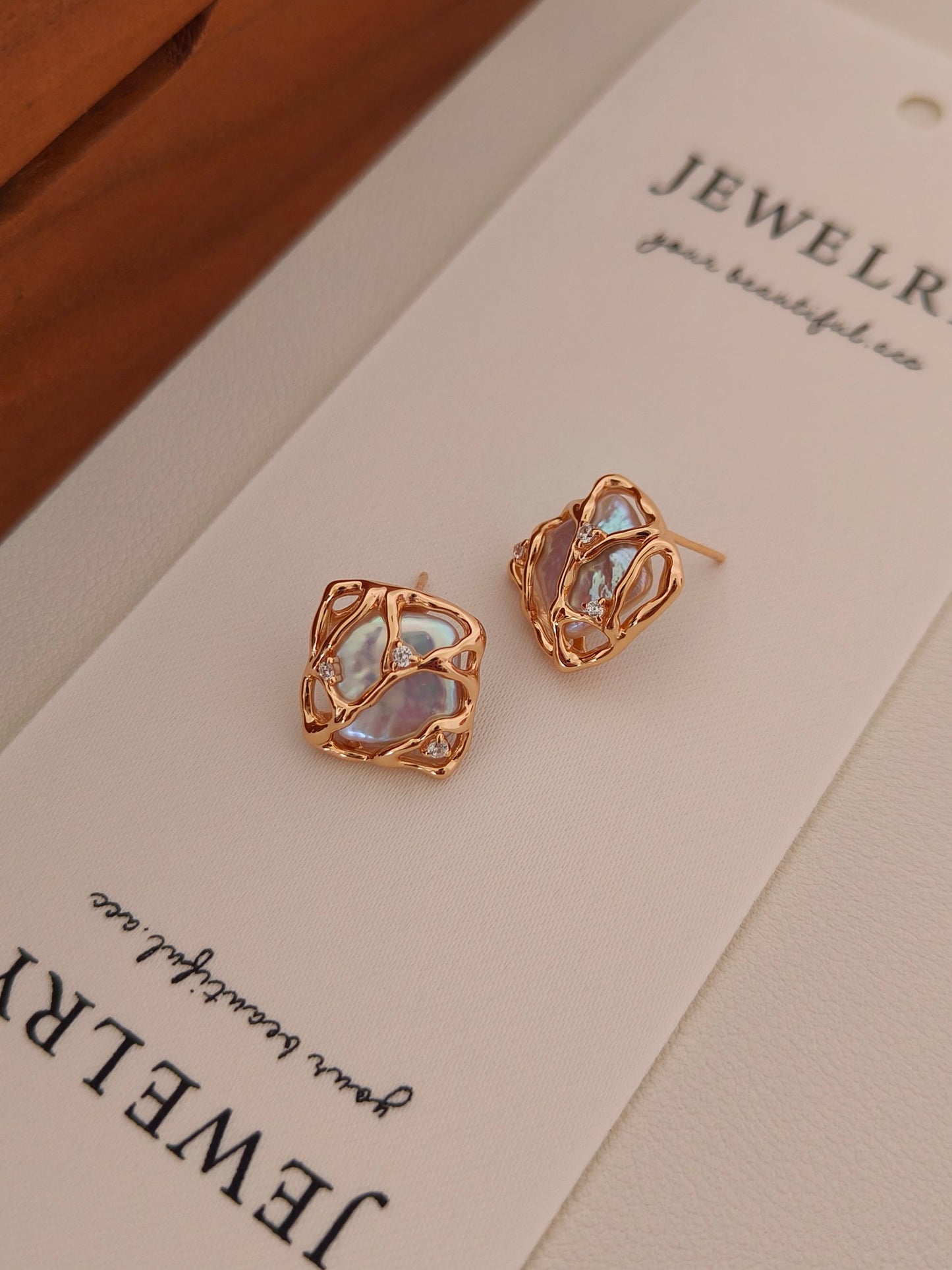 Close-up of the Gaia baroque pearl earrings on a Vera Lustre jewelry card, showcasing the high-luster finish and fine craftsmanship.