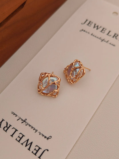 Close-up of the Gaia baroque pearl earrings on a Vera Lustre jewelry card, showcasing the high-luster finish and fine craftsmanship.