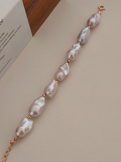 Vera Lustre "Luna" Baroque Pearl Bracelet displayed vertically, showcasing the substantial size and mesmerizing iridescent luster of each organic freshwater pearl against a clean background.