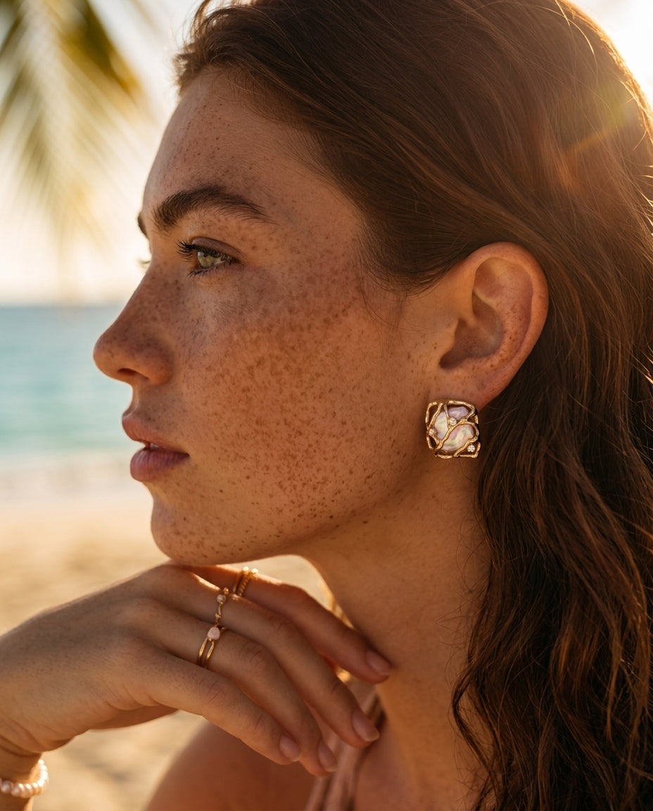 A lifestyle image of a woman wearing the Gaia woven pearl earrings, highlighting their architectural beauty and sophisticated "Quiet Luxury" 