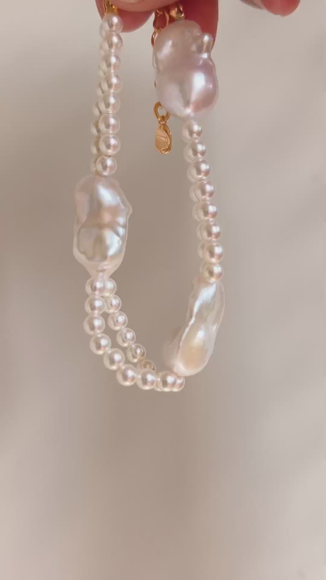 Detailed flat lay of the organic baroque pearls and seed pearls of the Isla bracelet, emphasizing the natural iridescence of each unique pearl.