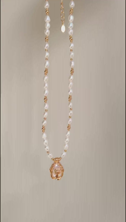 This cinematic video pans across the Elara necklace, capturing the shifting iridescence of the Mother-of-Pearl and the radiant glow of the pearl strand. The movement highlights the elegant drape of the 38cm chain and the shimmering details of the vintage medallion as it catches the light.