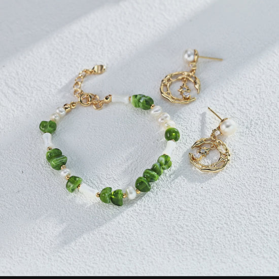 A cinematic video of the Astra earrings in motion. The footage captures the brilliant fire of the zircons and the shifting iridescent luster of the pearls as they sway gently, bringing the night sky to life.