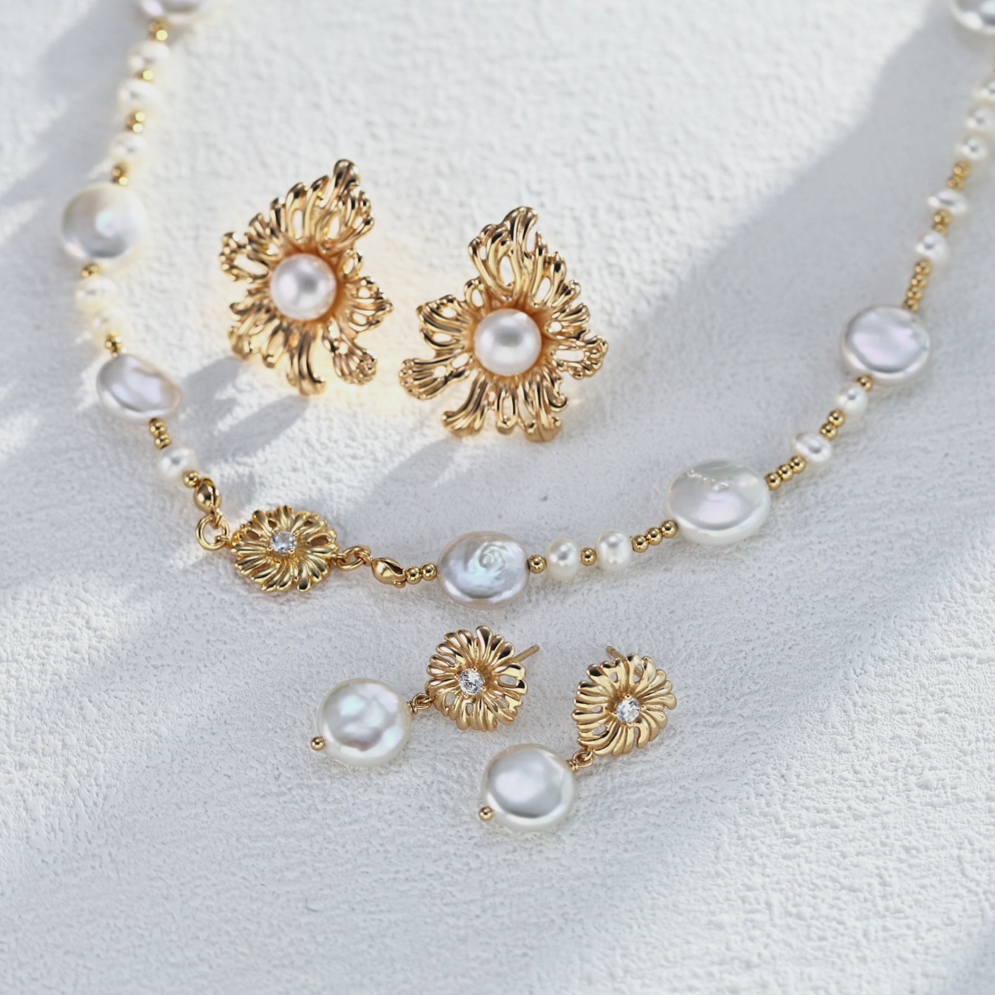 A cinematic video capturing the Cressida necklace in motion. As the piece turns, the CZ-pave bail flickers brilliantly, contrasting with the soft, iridescent luster of the freshwater pearls, illustrating the dynamic elegance of the design.