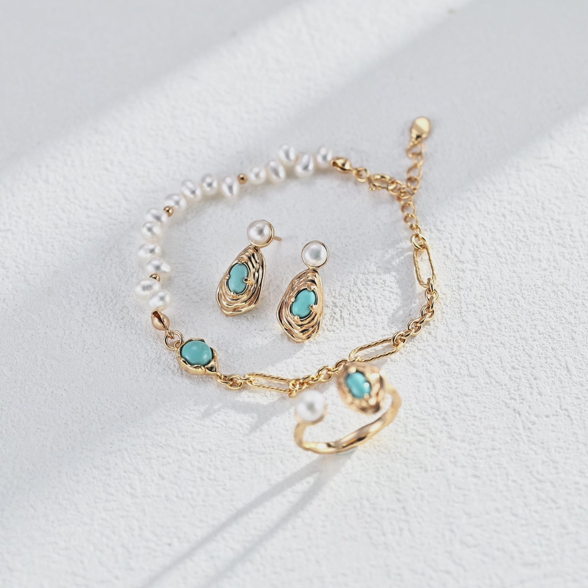 A cinematic video capturing the shimmering pearls and turquoise accents in natural light, emphasizing the bracelet's fluid movement and retro charm.