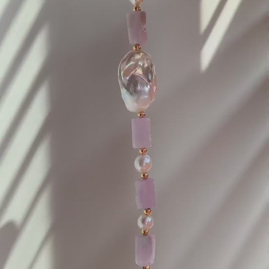 A cinematic video of the Liora bracelet in movement, showing the light dancing through the lavender crystals and reflecting off the satiny pearl surfaces.