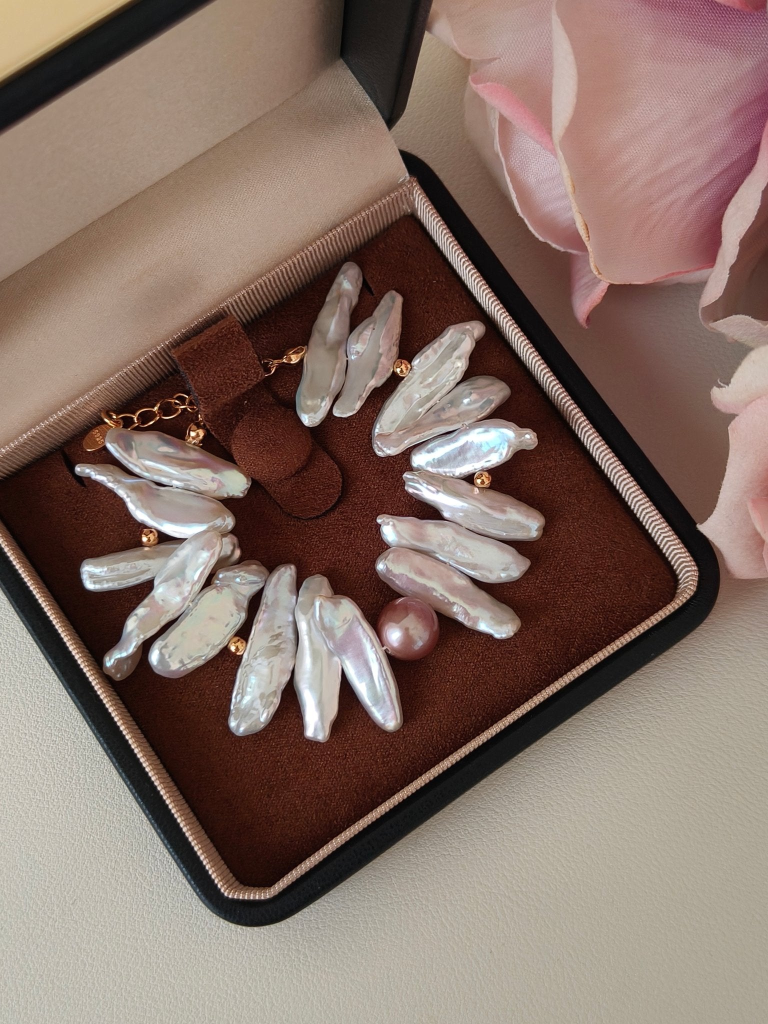 Baroque freshwater pearl bracelet with gold accents displayed in a luxury jewelry box, high lustre irregular pearls with pink accent pearl