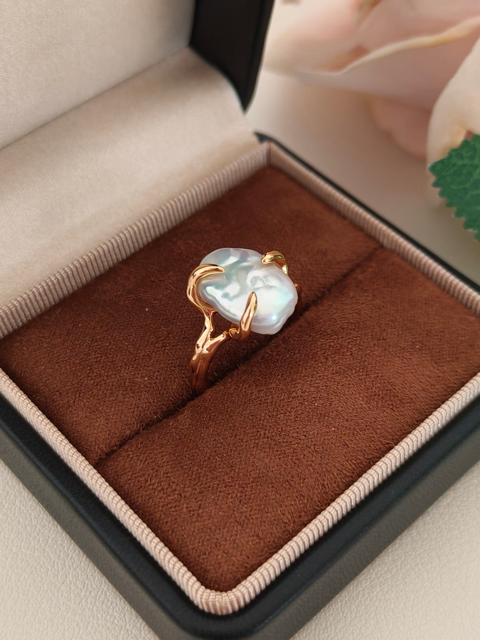 The Vera Lustre Aura baroque pearl ring elegantly presented in a premium jewelry box, showcasing its bold and modern silhouette.
