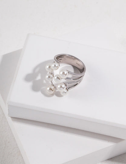 A high-contrast shot featuring both the gold and silver Sia rings side-by-side, illustrating the versatility of the mixed-metal collection for stacking or solo wear.