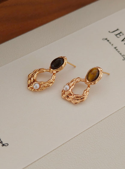 A macro shot focusing on the unique "cat's eye" effect (chatoyancy) of the Tiger's Eye stone, reinforcing the brand's commitment to authentic, high-grade gemstones.