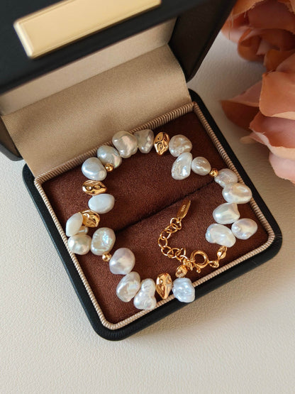 A close-up detail of the 18K gold-plated S925 silver textures, showcasing the artisanal "nugget" design that mirrors the organic pearl forms.