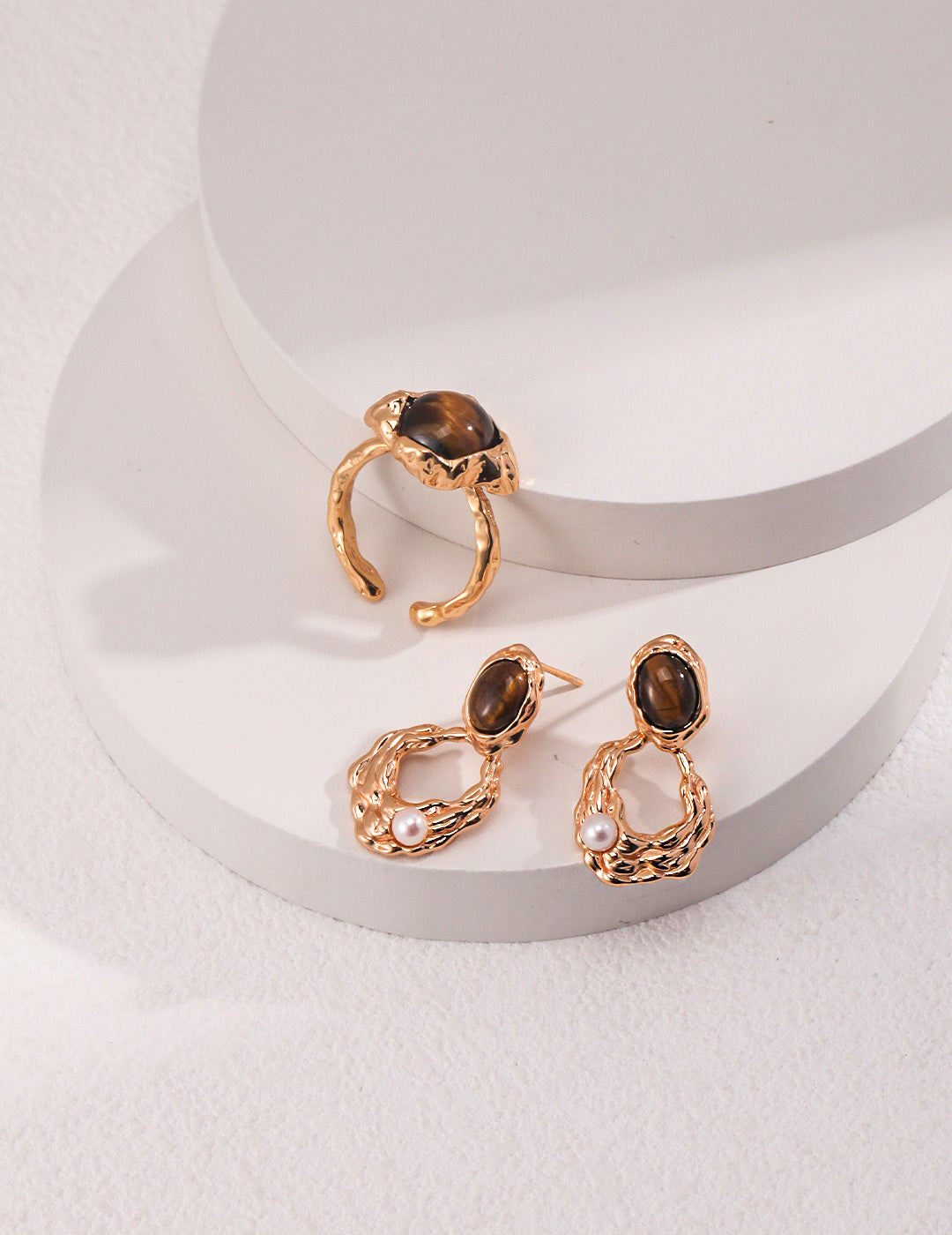 A clean profile view emphasizing the sculptural golden architecture and the secure drop design, targeting customers seeking metaphysical-inspired fine jewelry.