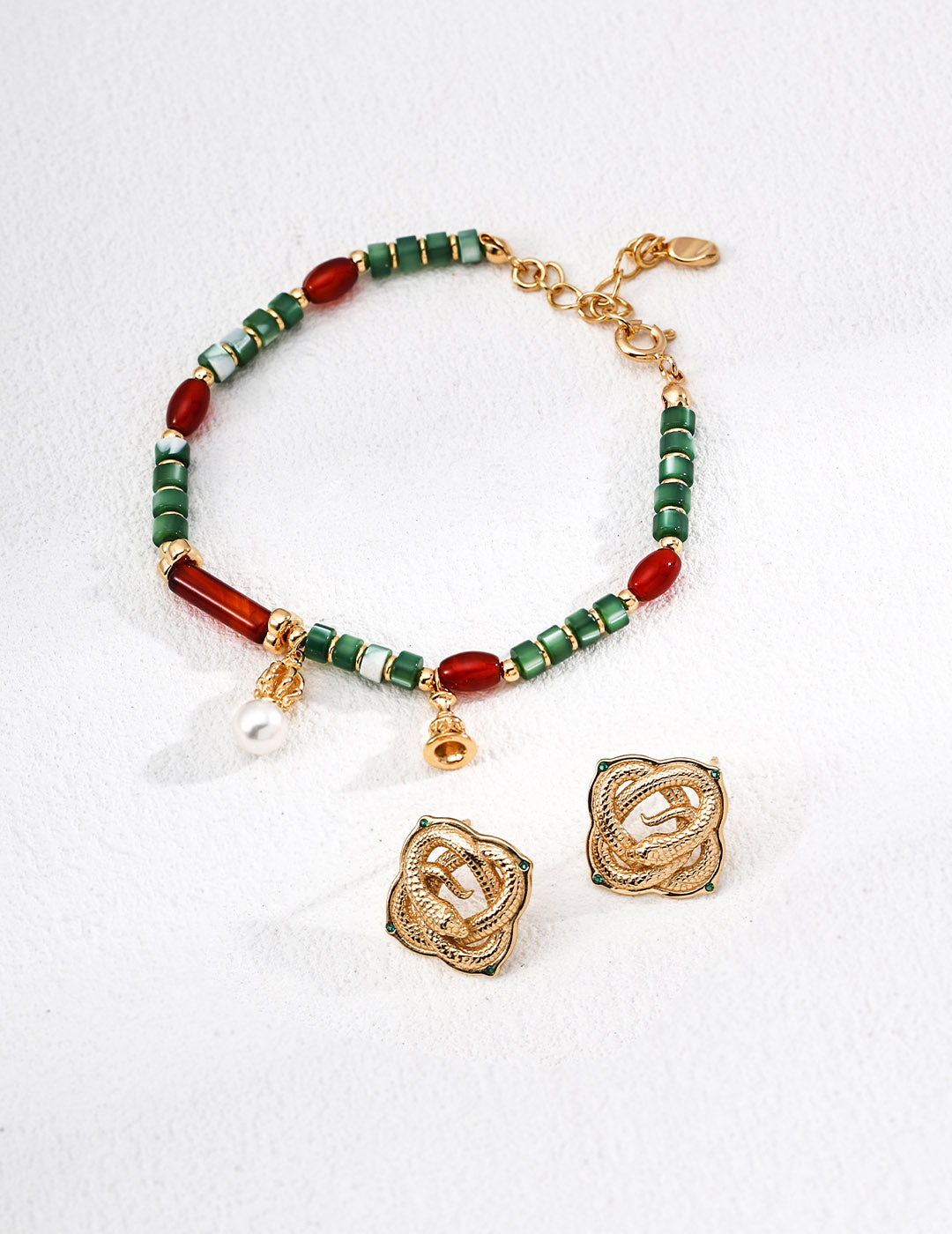 A flat lay featuring the Iris matching jewelry set, illustrating the perfect color coordination between the beaded bracelet and the artisanal drop earrings.