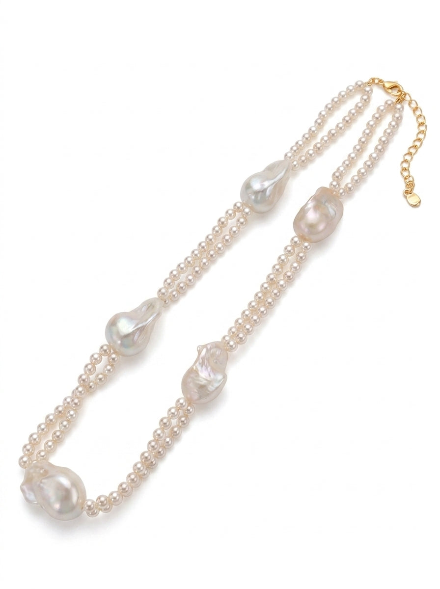 Front view of Selene tiered necklace showing the contrast between micro seed pearls and large organic baroque pearls.