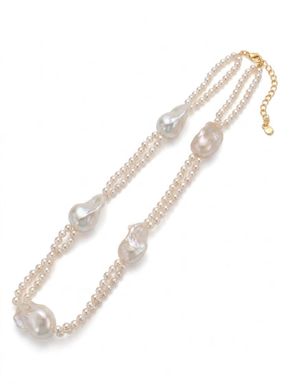 Front view of Selene tiered necklace showing the contrast between micro seed pearls and large organic baroque pearls.