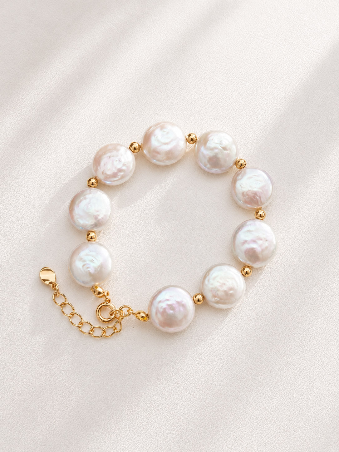 Vera Lustre "Selene" Coin Baroque Pearl Bracelet featuring iridescent flat pearls and 18K Gold Vermeil accents on a white background.