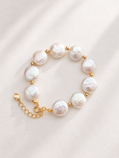 Vera Lustre "Selene" Coin Baroque Pearl Bracelet featuring iridescent flat pearls and 18K Gold Vermeil accents on a white background.