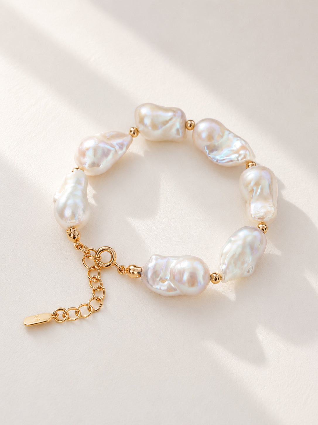 Vera Lustre "Luna" Bracelet featuring large, organic baroque pearls on a 925 sterling silver chain plated in 18K gold.