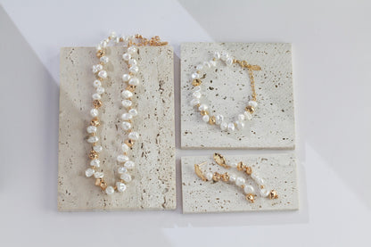 A curated display of the Elysian collection, featuring the matching necklace, bracelet, and drop earrings. This visual emphasizes the cohesive design language of Vera Lustre, encouraging coordinated jewelry set purchases for a complete, high-end artisanal look.