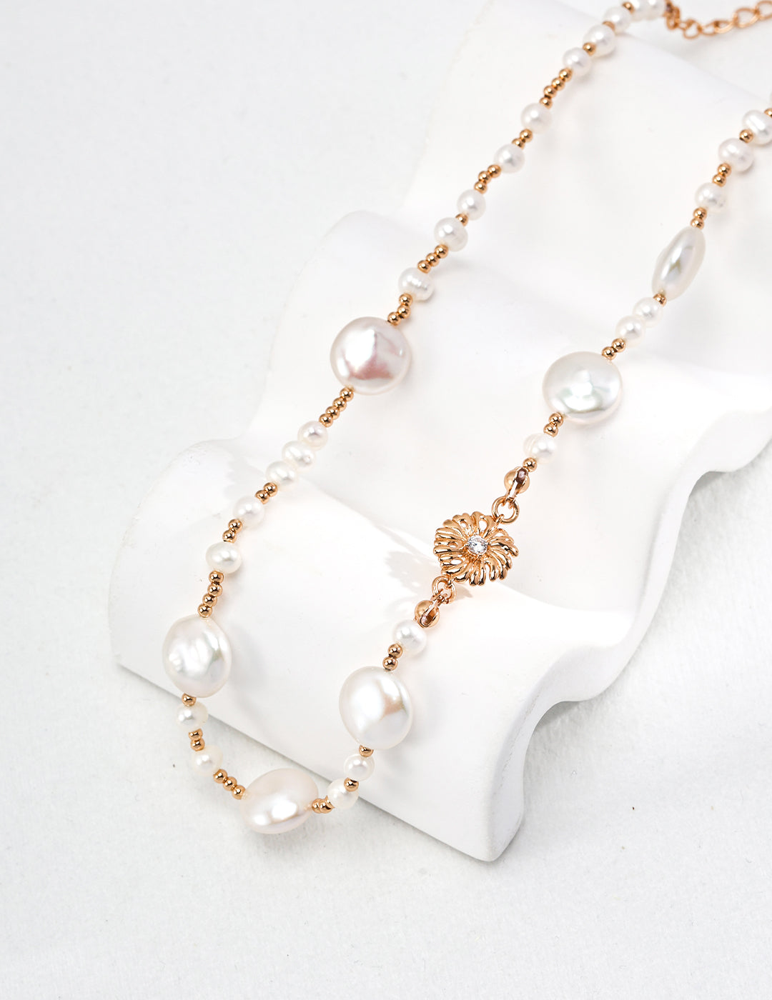A macro close-up of the natural baroque pearl pendant, showcasing its unique organic texture and the precision-set cubic zirconia stones. This visual targets customers seeking artisan pearl jewelry with intricate, high-end finishing.