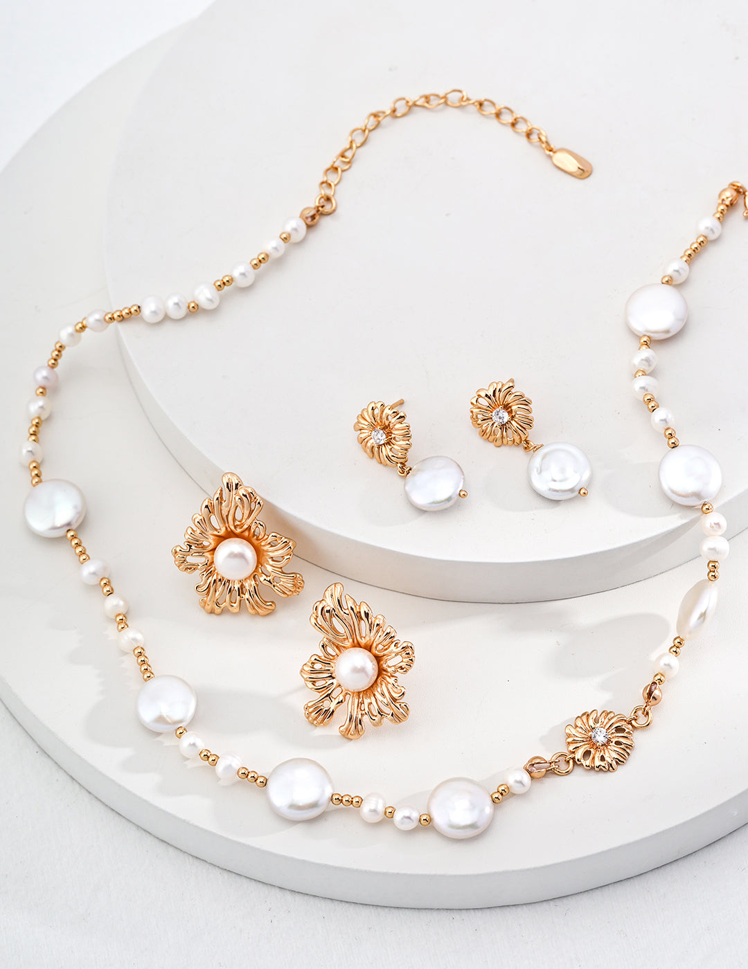 A curated flat lay of the Cressida jewelry set, featuring the matching necklace and bracelet. This image encourages coordinated luxury set purchases, highlighting the consistent design language of the Vera Lustre brand.