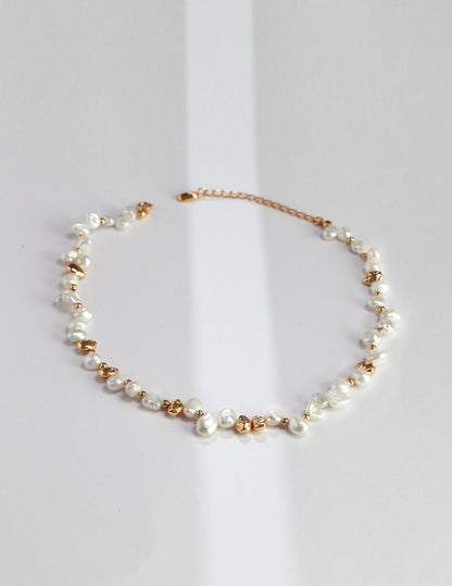 A high-resolution studio shot of the Elysian necklace on a clean background. This main image displays the striking contrast between the creamy, iridescent baroque pearls and the hand-finished silver nuggets, emphasizing the brand's commitment to handcrafted, artisan luxury jewelry.