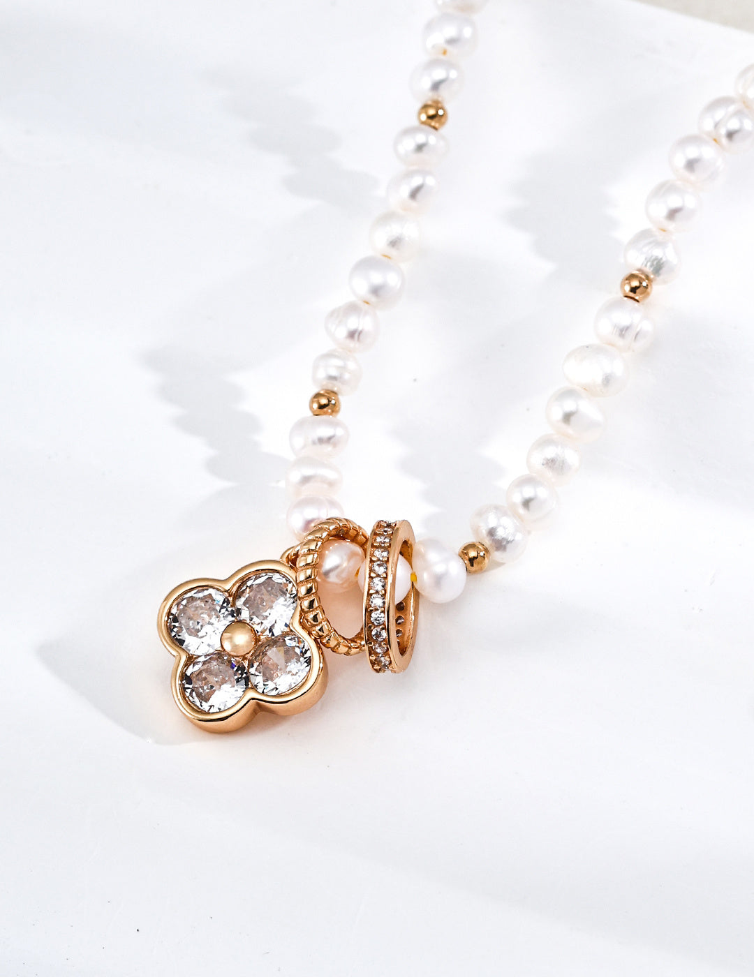 A macro close-up of the four-leaf clover charm, revealing the intricate setting of the cubic zirconia stones. This visual targets customers looking for symbolic jewelry with high-end, artisan-level detailing.
