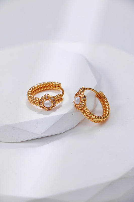 A clean studio shot of the Lumia earrings, showcasing the balance between the polished S925 silver hoop and the round natural pearl.