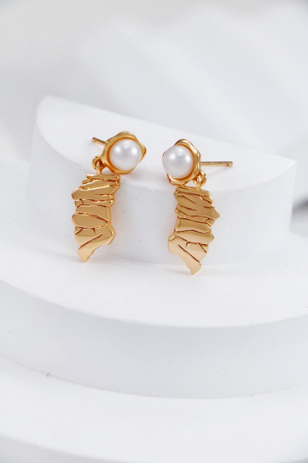 A side view of the earrings, showcasing the high-relief weathered metal texture and the secure S925 sterling silver setting.