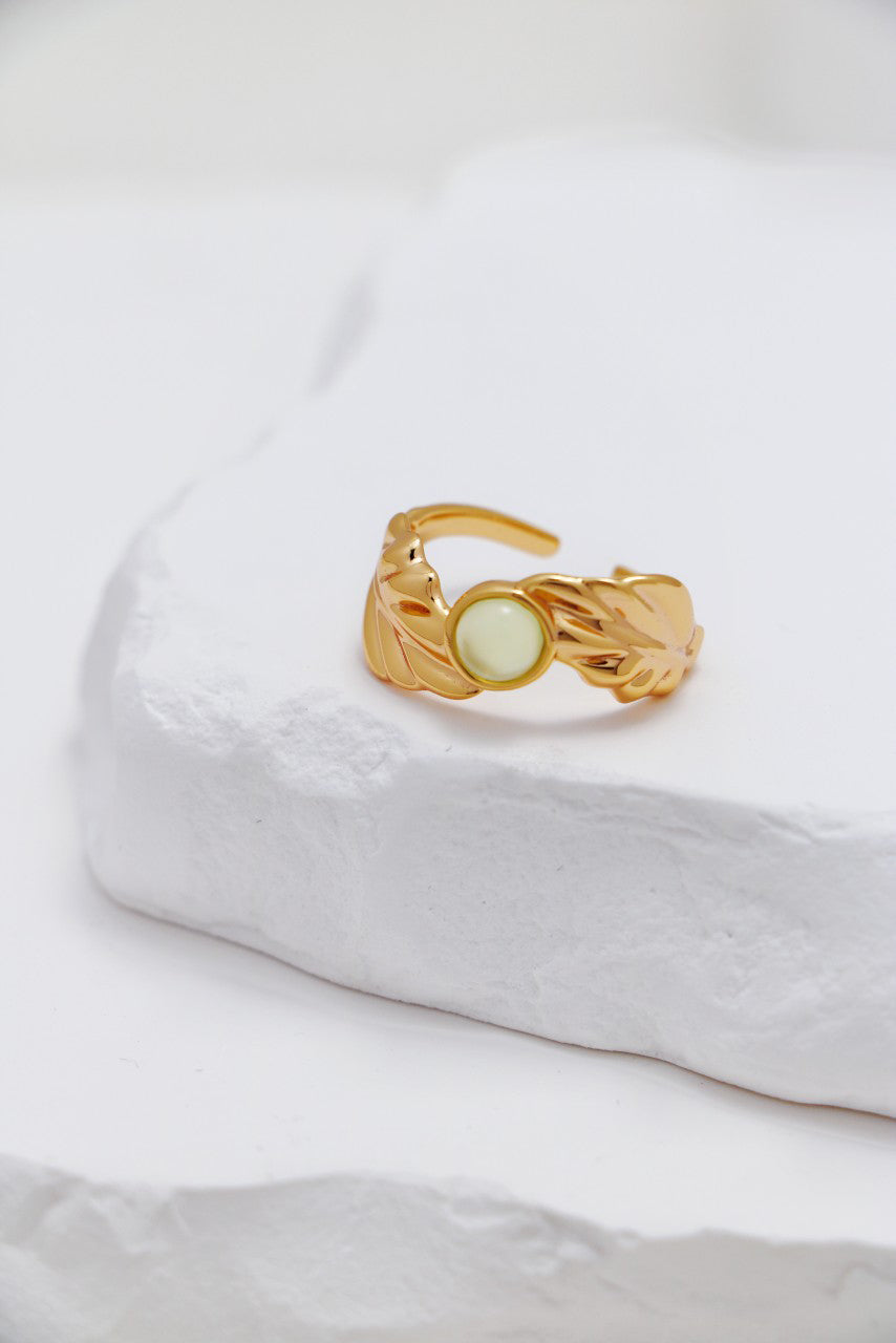 A professional studio shot of the Odile Pink Chalcedony ring, highlighting the sculptural Calla Lily design and the soft, translucent pink glow of the gemstone.