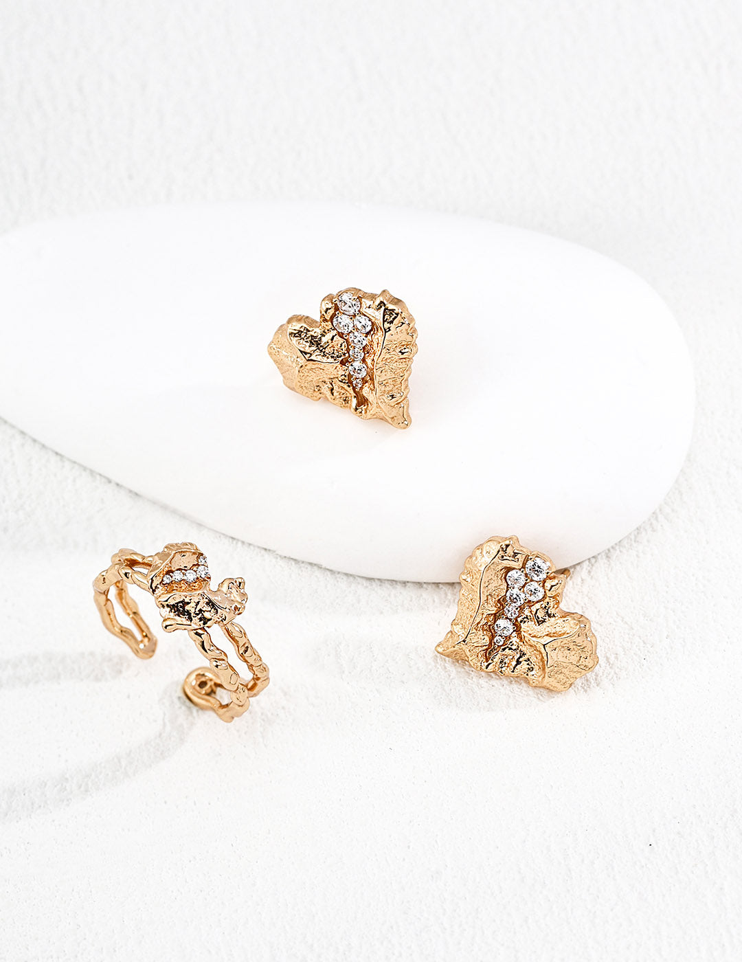 A curated flat lay of the Kardia earrings paired with a matching gold necklace, demonstrating a cohesive vintage-inspired statement set.