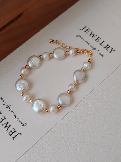 A detailed close-up focusing on the sculptural metal textures and the authentic, non-uniform surface of the natural pearls, emphasizing the handcrafted S925 silver quality.