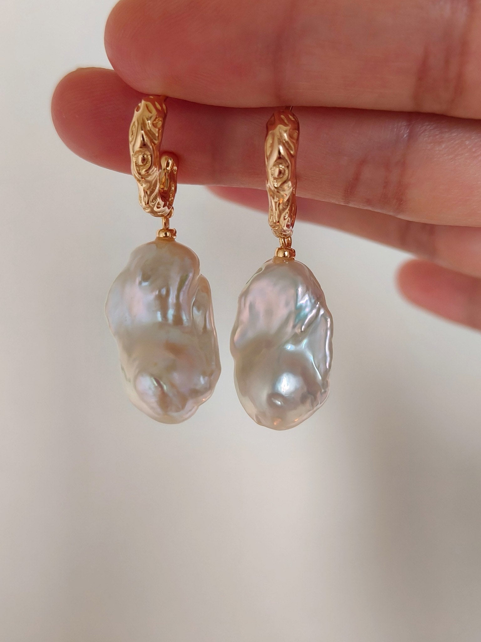 A close-up view of the vintage gold S925 hooks, emphasizing the secure, elegant hardware and the authentic, non-uniform beauty of the pearl pair.