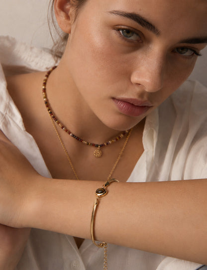 A lifestyle shot of the Cyra set worn together, demonstrating the elegant proportions and the rhythmic color story of blue and gold across the collection.