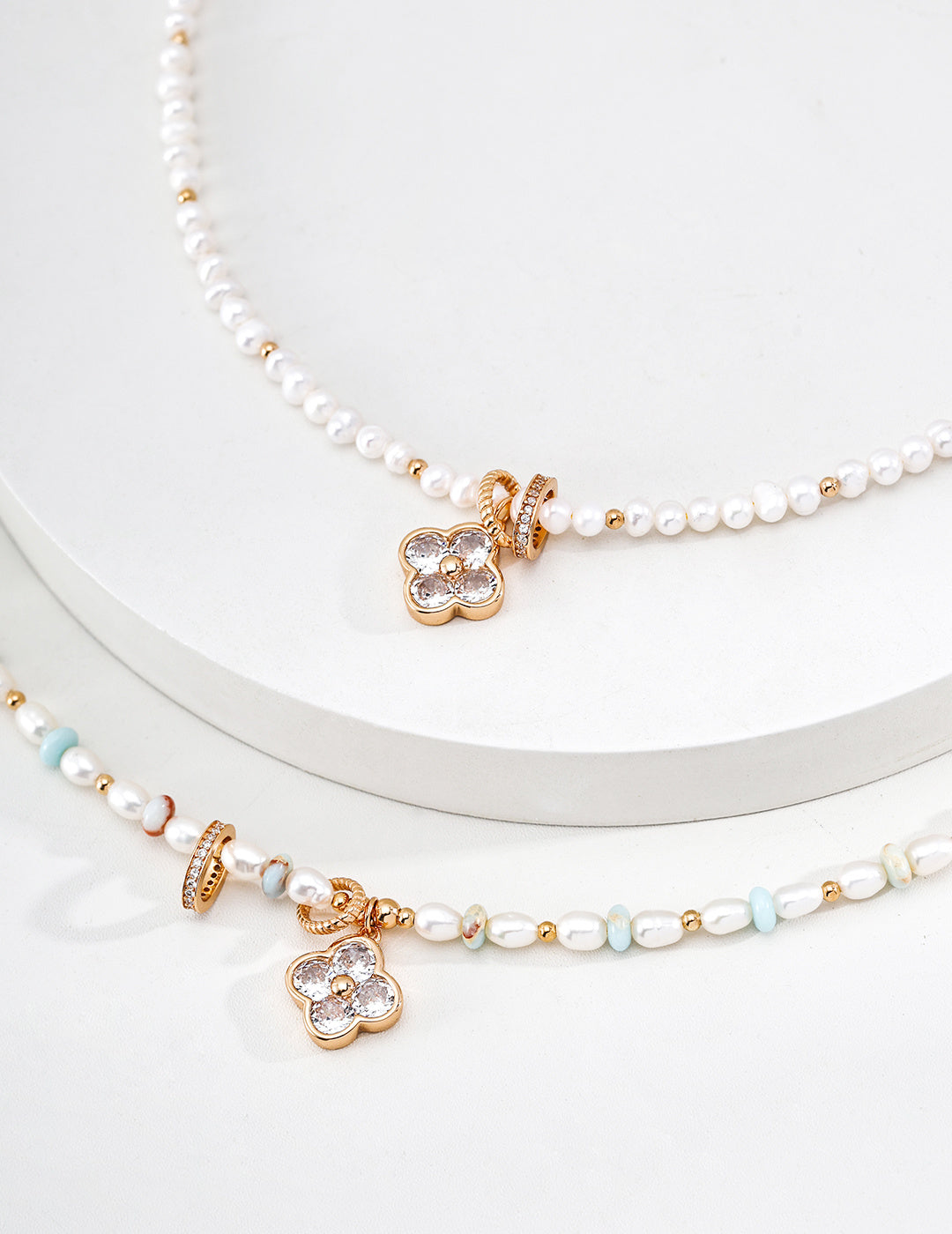 A focused view of the natural freshwater pearls and the secure vintage gold hardware. This reinforces the "organic luxury" feel and the brand's commitment to hypoallergenic, premium materials.