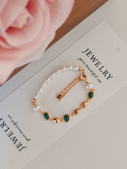 A macro close-up focusing on the Malachite and Pearl duo, emphasizing the secure bezel setting and the authentic quality of the S925 sterling silver craftsmanship.