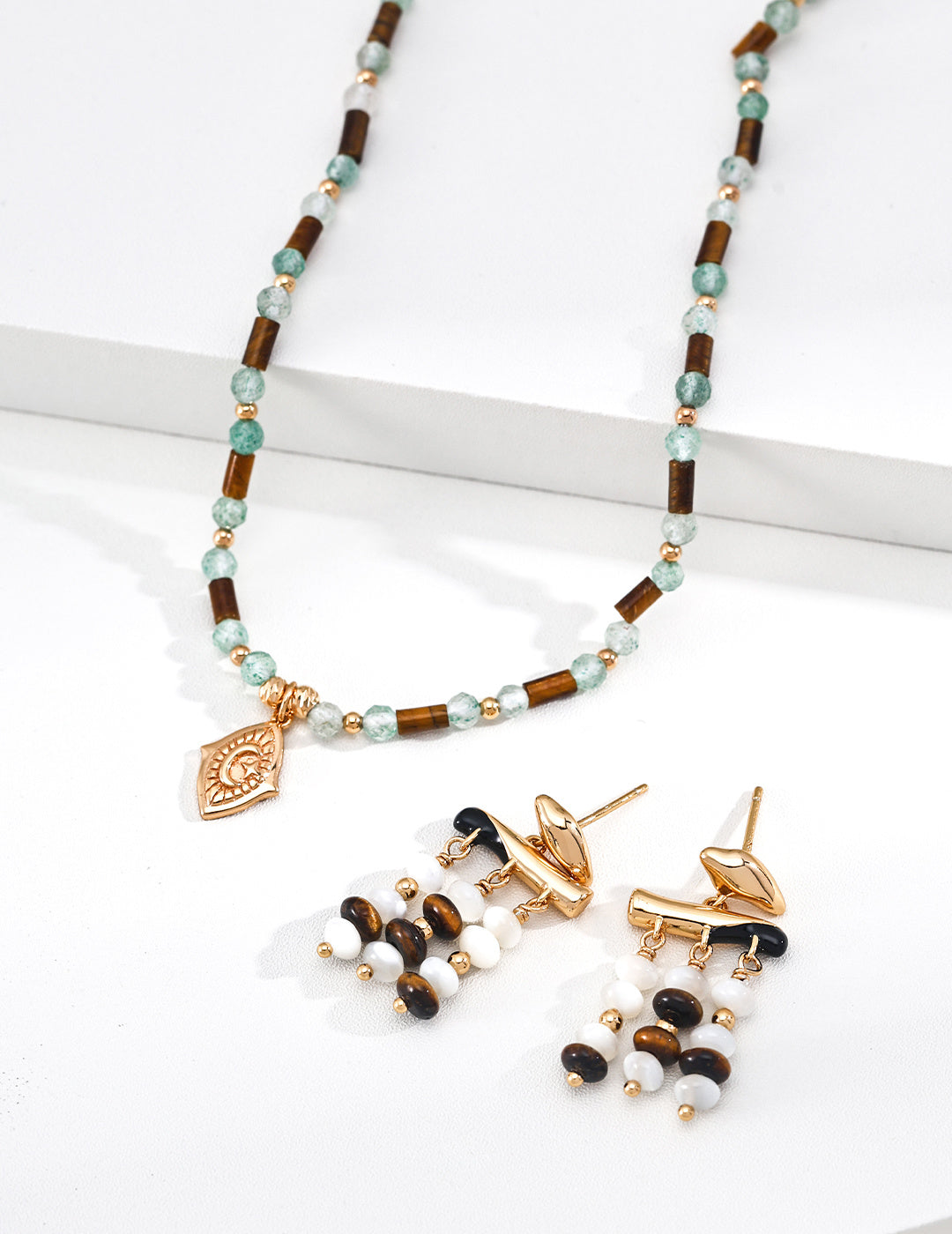 A curated display of the Gaia collection, featuring the matching beaded necklace and drop earrings. This visual highlights the cohesive design language of Vera Lustre, encouraging gemstone jewelry set purchases for a complete, earth-inspired look.