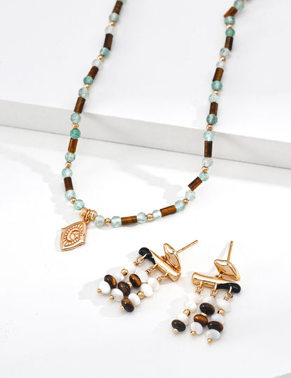 A curated display of the Gaia collection, featuring the matching beaded necklace and drop earrings. This visual highlights the cohesive design language of Vera Lustre, encouraging gemstone jewelry set purchases for a complete, earth-inspired look.