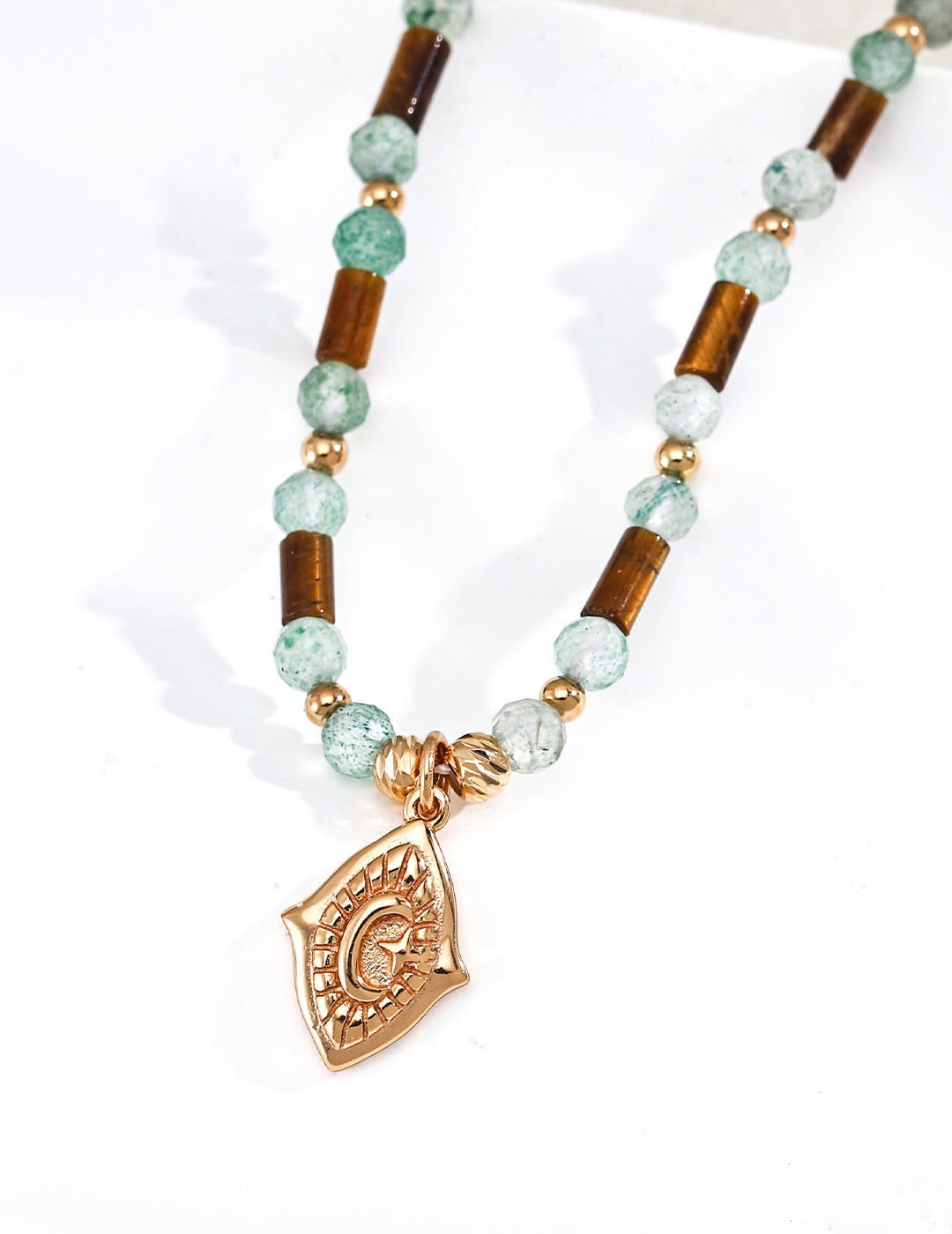 A macro close-up focusing on the translucent clarity of the Green Strawberry Quartz and the silky luster of the Tiger’s Eye. This visual targets customers seeking natural gemstone jewelry with authentic, high-quality textures and artisanal details.