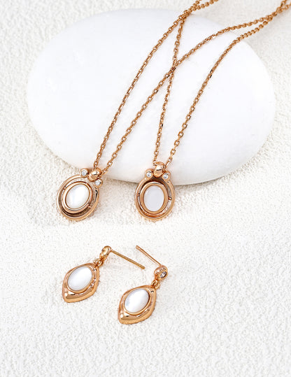 A crisp display of the Astra Mother of Pearl jewelry set, featuring the iridescent white shell inlay in both the necklace and matching pieces. The soft glow of the natural white shell is contrasted by a halo of sparkling cubic zirconia, emphasizing the premium S925 sterling silver craftsmanship and a clean, luxury aesthetic.
