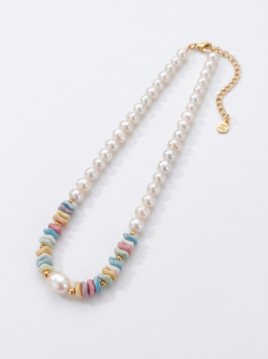 Front view of the Ondine tiered necklace showing the contrast between petite seed pearls and large organic baroque pearls.