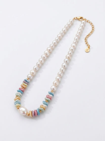 Front view of the Ondine tiered necklace showing the contrast between petite seed pearls and large organic baroque pearls.