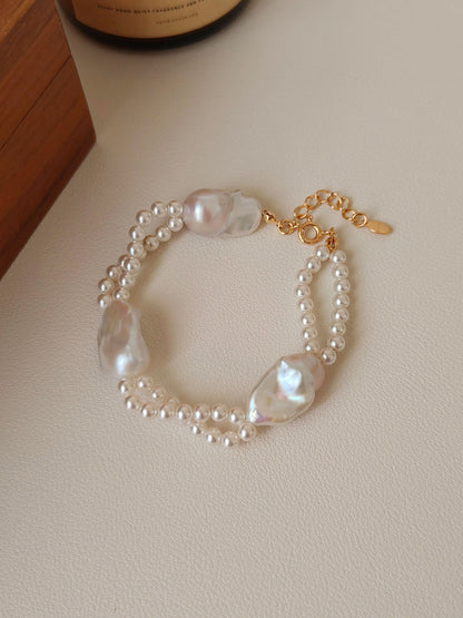 Detailed flat lay of the organic baroque pearls and seed pearls of the Isla bracelet, emphasizing the natural iridescence of each unique pearl.