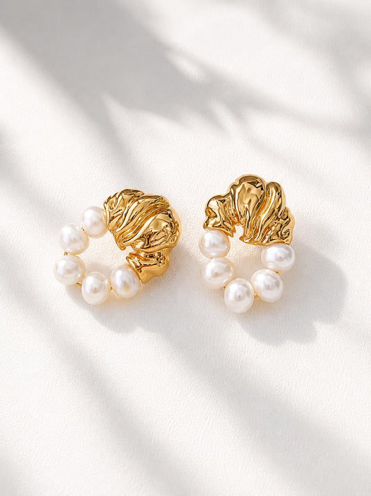 A professional studio shot of the Eos pearl drops, showcasing the distinct, irregular shapes of the natural freshwater pearls. This primary image highlights the S925 sterling silver quality and the radiant golden luster.